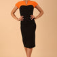 Model wearing the Diva Bryony Contrast dress with contrasting top and exposed zip at the back in black and sun orange front image