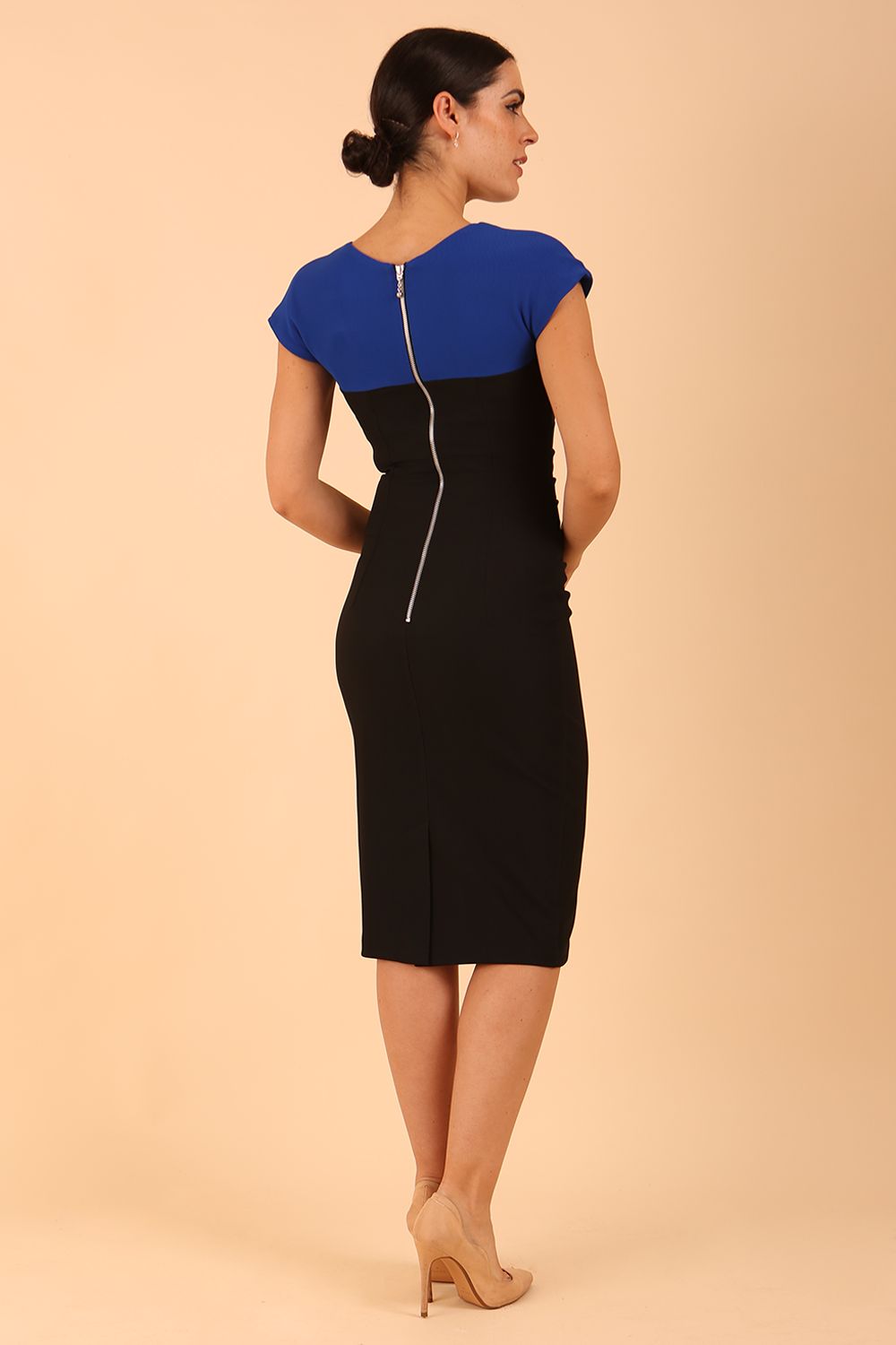 Model wearing the Diva Bryony Contrast dress with contrasting top and exposed zip at the back in black and cobalt blue back image