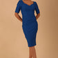 model wearing diva catwalk couture wiltshire fitted pencil-skirt dress with short sleeves and open v-neckline and pleating across the tummy area in sapphire blue colour front