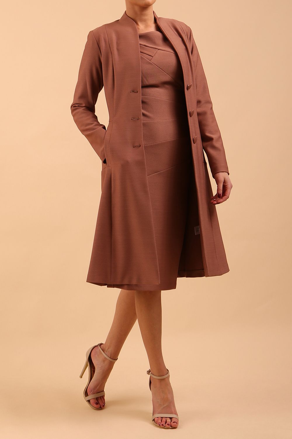  model wearing diva catwalk couture fine raquella coat with buttons across the front and long sleeves with high neck and pockets in citrus green colour front