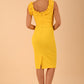 brunette model is wearing diva catwalk odessa pencil sleeveless dress with frill detail on rounded neckline in freesia yellow back