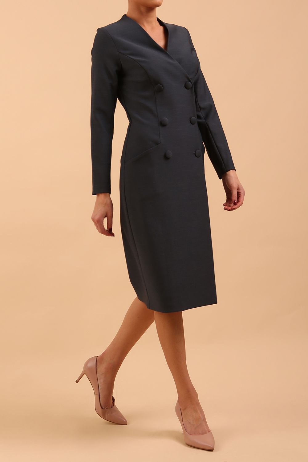 Brunette model wearing a diva catwalk Seed Silverstone Long Sleeve Coat Dress with 6 buttons across the front and pockets in colour Slate Grey front side