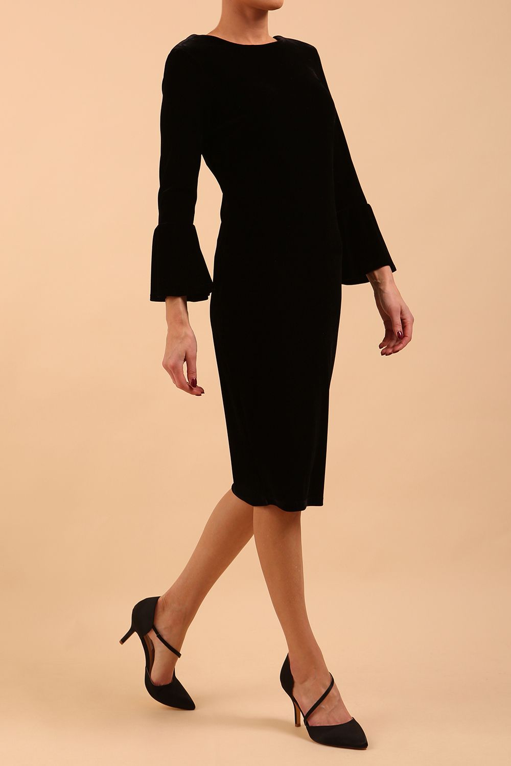 A brunette model is wearing a velvet long bell sleeve pencil dress maternity style in black colour front