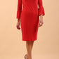 A brunette model is wearing a velvet long bell sleeve pencil dress maternity style in hibiscus red colour front