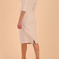 model is wearing diva catwalk seed axford pencil sleeved dress with rounded folded collar in Sandy Cream back side