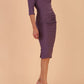 model wearing seed couture royale pencil skirt dress with pleating across the tummy area with rounded neckline with a split in the middle and 3 4 sleeve in Dusky Lilac colour front side