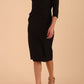 Model wearing diva catwalk Seed Andante Pencil Skirt Dress with 3/4 sleeve and bow detail at waistline in Black front side