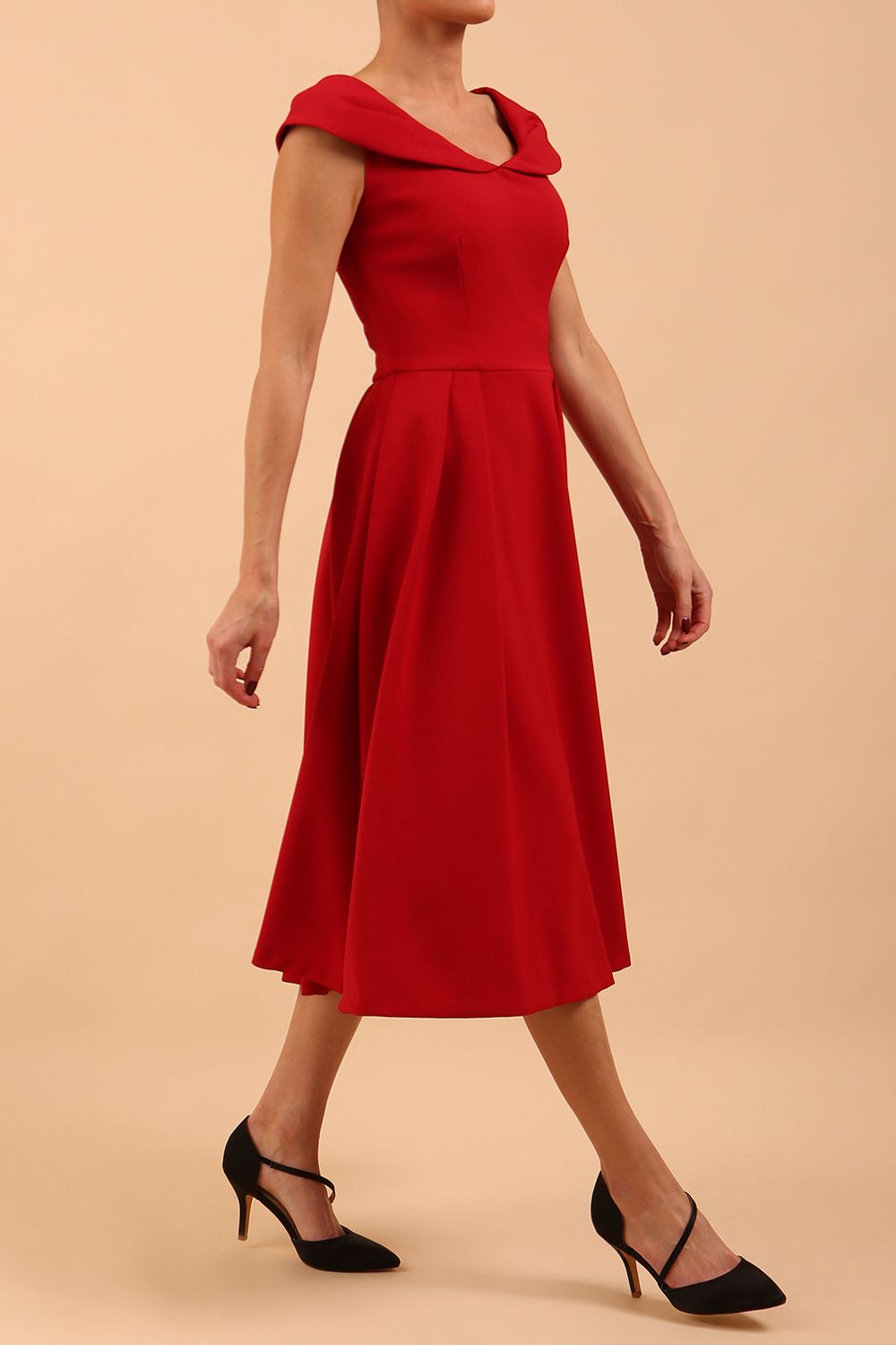 Model wearing the Diva Chesterton Sleeveless dress with oversized collar detail and swing pleated skirt in dark red front image