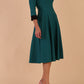 Model wearing Diva catwalk Coralia swing dress in pacific green / black contrast with three quarter sleeve figure fitted front image