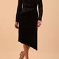 Brunette Model wearing assymetric glitter and black velvet long sleeve dress front image