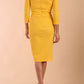 Model wearing diva catwalk Trixie dress in Sunrise Yellow back