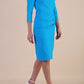 Model wearing diva catwalk Trixie dress in Turquoise Blue side