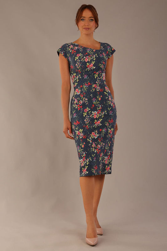 Model wearing the Nora asymmetric floral jacquard dress, showcasing the unique draped neckline (Navy Floral)