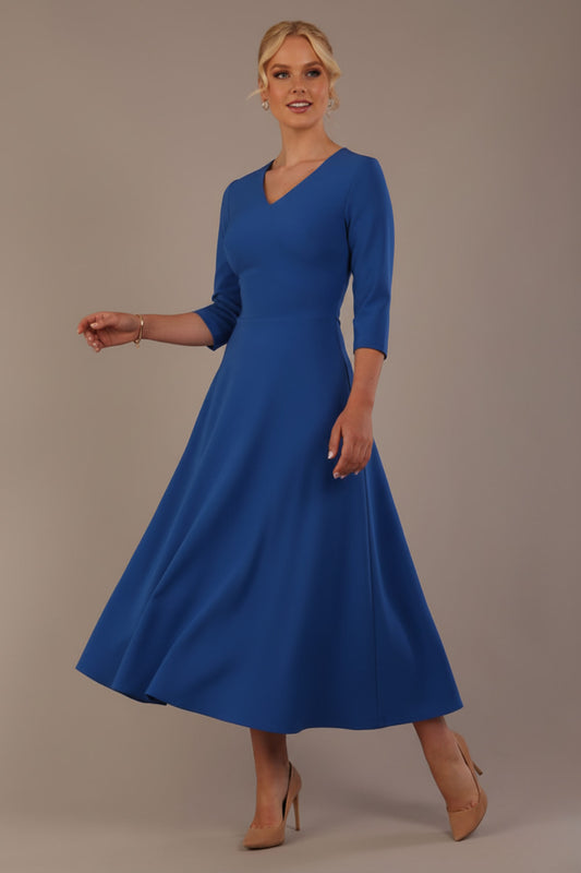 Woman wearing a blue dress against a plain background (Imperial Blue)