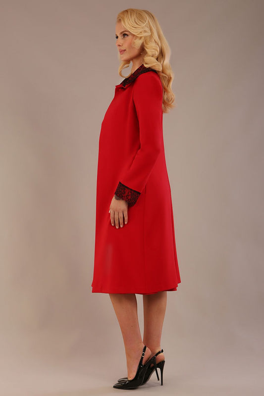 Side view of the Haven coat in salsa red, showing the lace cuff detail and the fluid drape of the couture fabric (Salsa Red)