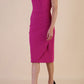 brunette model wearing diva catwalk evening pencil skirt dress sleeveless with lowered neckline and pleating on side in magenta colour front