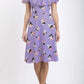 model is wearing diva catwalk layla a-line swing printed dress without sleeves in purple triangles print front