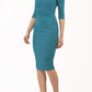 Model wearing the Diva Carlotta Pencil dress with pleat detail at the neckline and across the front in mosaic blue front image