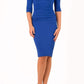 model is wearing diva catwalk pinhoe pencil dress with sleeved and high neckline with a keyhole detail in the middle and pleating across the tummy area in cobalt blue front