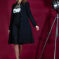 brunette model wearing diva catwalk couture fine raquella coat with buttons across the front and long sleeves with high neck and pockets in black colour front  Edit alt text