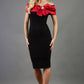 blonde model wearing diva catwalk samantha off shoulder pencil dress with satin red bow detail with a diamante brooch in black front
