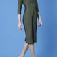 model wearing seed bertie dress with sleeves and rounded neckline with lace details pointing towards the band in olive green front