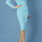 model is wearing diva catwalk cynthia long sleeve pencil dress with low v-neckline in celeste blue front
