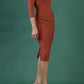 model is wearing diva catwalk pencil dress with contrasting asymmetric satin neckline in marsala brown front