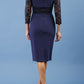 model is wearing diva catwalk bucklebury lace dress with sleeved and low neckline in navy blue back