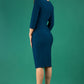 Model wearing the Diva Daphne ¾ Sleeved dress with pleat detail across the hips and ¾ sleeve length in teal back image  Edit alt text