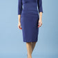 Model wearing the Diva Daphne ¾ Sleeved dress with pleat detail across the hips and ¾ sleeve length in navy front