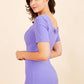 model wearing diva catwalk mitzi short sleeve pencil dress with square frilled neckline in fusion indigo front 