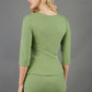 blonde model is wearing diva catwalk courtney sleeved topin colour aspen green back paired with green top 