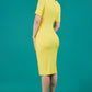 model is wearing diva catwalk seed barton short sleeve pencil dress with v-neck in daffodil yellow back