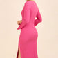 brunette model wearing diva catwalk chloe pencil skirt dress with long sleeves with deep slit and low v-neckline with tuxedo collar detailing in pink colour back