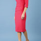 model is wearing diva catwalk seed axford pencil sleeved dress with rounded folded collar in opera pink side