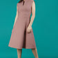 Brunette Model is wearing a sleeveless swing high neck dress with high neck in acorn brown by Diva Catwalk front