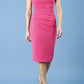 model is wearing diva catwalk polly cap sleeve pencil dress with rounded neckline at the front and deep lowered rounded cutout at the back in fuchsia pink front