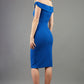 model wearing diva catwalk cloud pencil fitted flattering dress off shoulder sleeveless with detail with pleating around the front in cobalt back