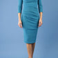 model is wearing diva catwalk polly sleeved pencil dress with low rounded neckline at the back in mosaic blue front