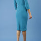 model is wearing diva catwalk polly sleeved pencil dress with low rounded neckline at the back in mosaic blue side