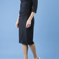 model is wearing diva catwalk quatro sleeved pencil dress with asymmetric wide cut our neckline in black front