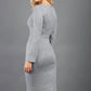 blonde model wearing diva catwalk elstar pencil plain dress made of very soft and cosy cashmere fabric with long sleeves in grey back
