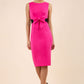 blonde model wearing Diva Catwalk Pencil sleeveless dress with rounded neckline and bow detail at the front with a contrasting black band in hibiscus pink front