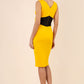 blonde model wearing Diva Catwalk Pencil sleeveless dress with rounded neckline and bow detail at the front with a contrasting black band in saffron yellow back