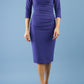 model wearing Diva Catwalk pencil three quarter sleeve dress with a split neckline and pleating across the tummy in deep orient blue front
