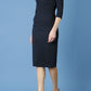 model wearing Diva Catwalk pencil three quarter sleeve dress with a split neckline and pleating across the tummy in midnight blue side