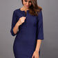 Model wearing Diva catwalk Minette dress in navy blue with three quarter sleeve figure fitted pencil dress front image