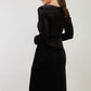 Brunette Model wearing assymetric glitter and black velvet long sleeve dress back image