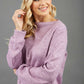 blonde model wearing diva catwalk hudson top with long sleeves and boat neckline in very soft cosy cashmere fabric in pink colour front with aria joggers matching the top front
